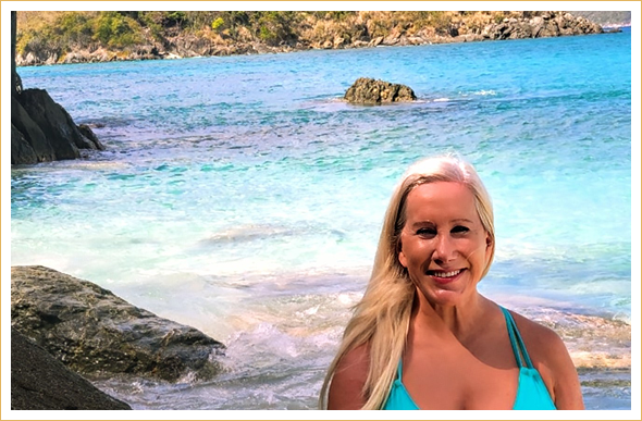 Happy woman near ocean rocks